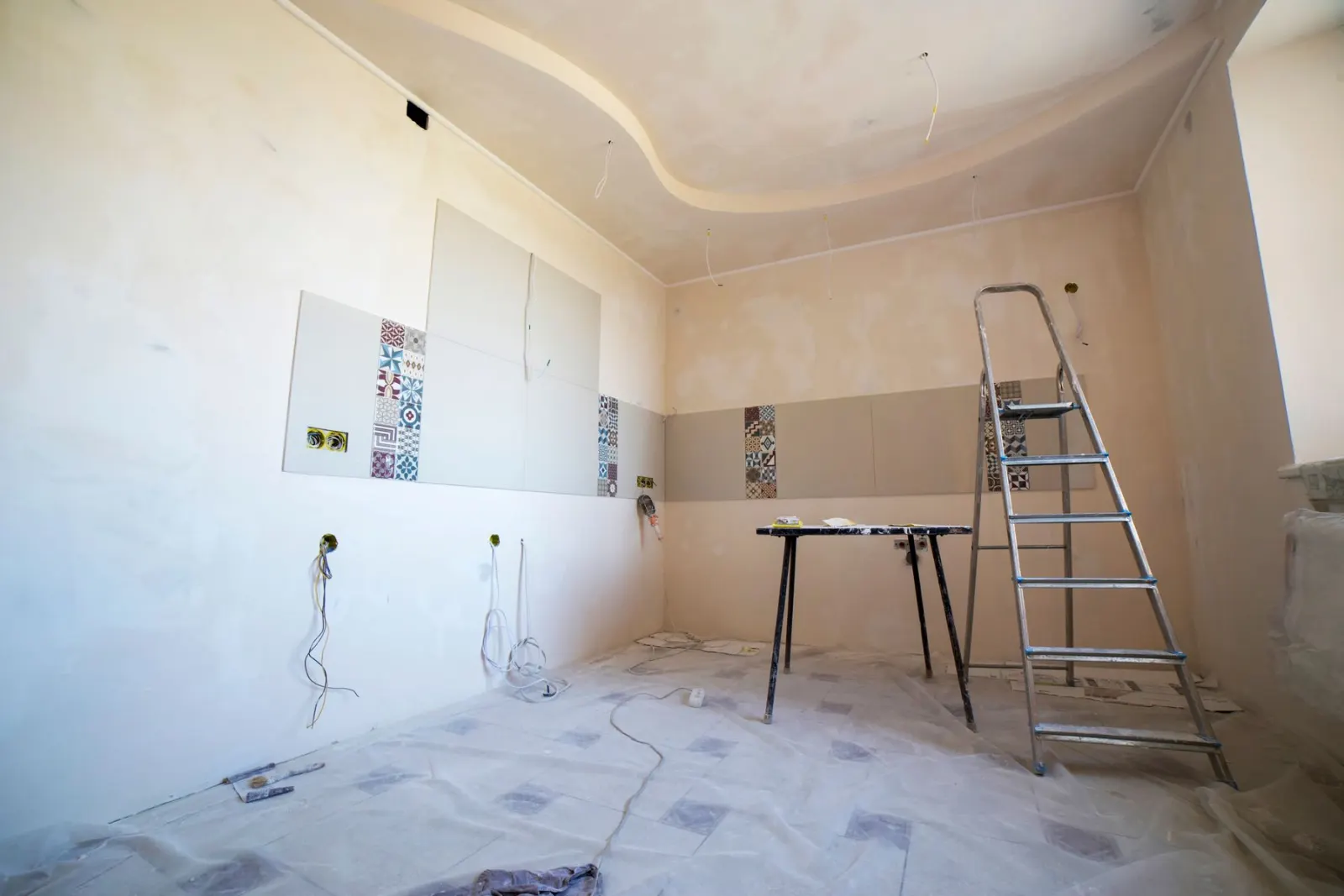 Ladders and boards in a room being fitted out