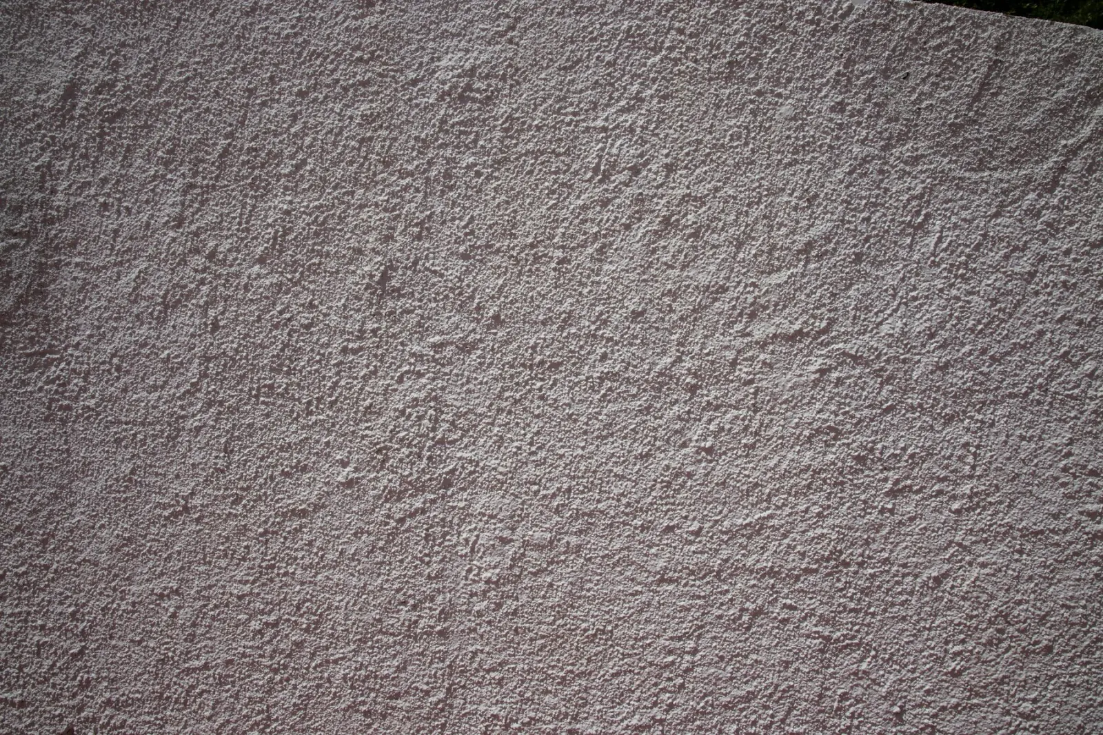 A dark stucco surface showing its texture