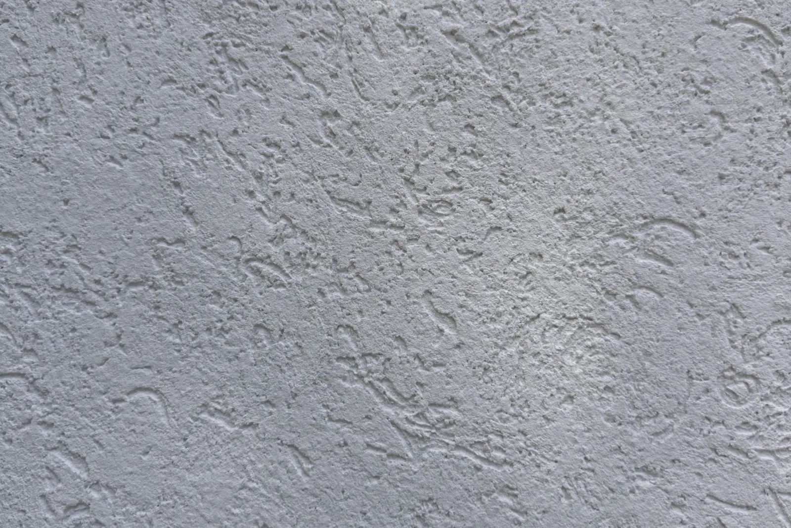 A clean rendered wall surface seen close up