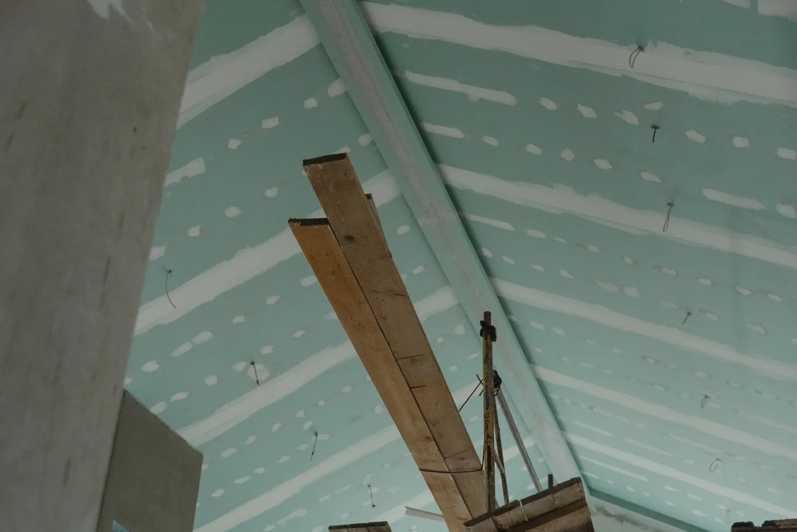Timber and board materials stacked in a room